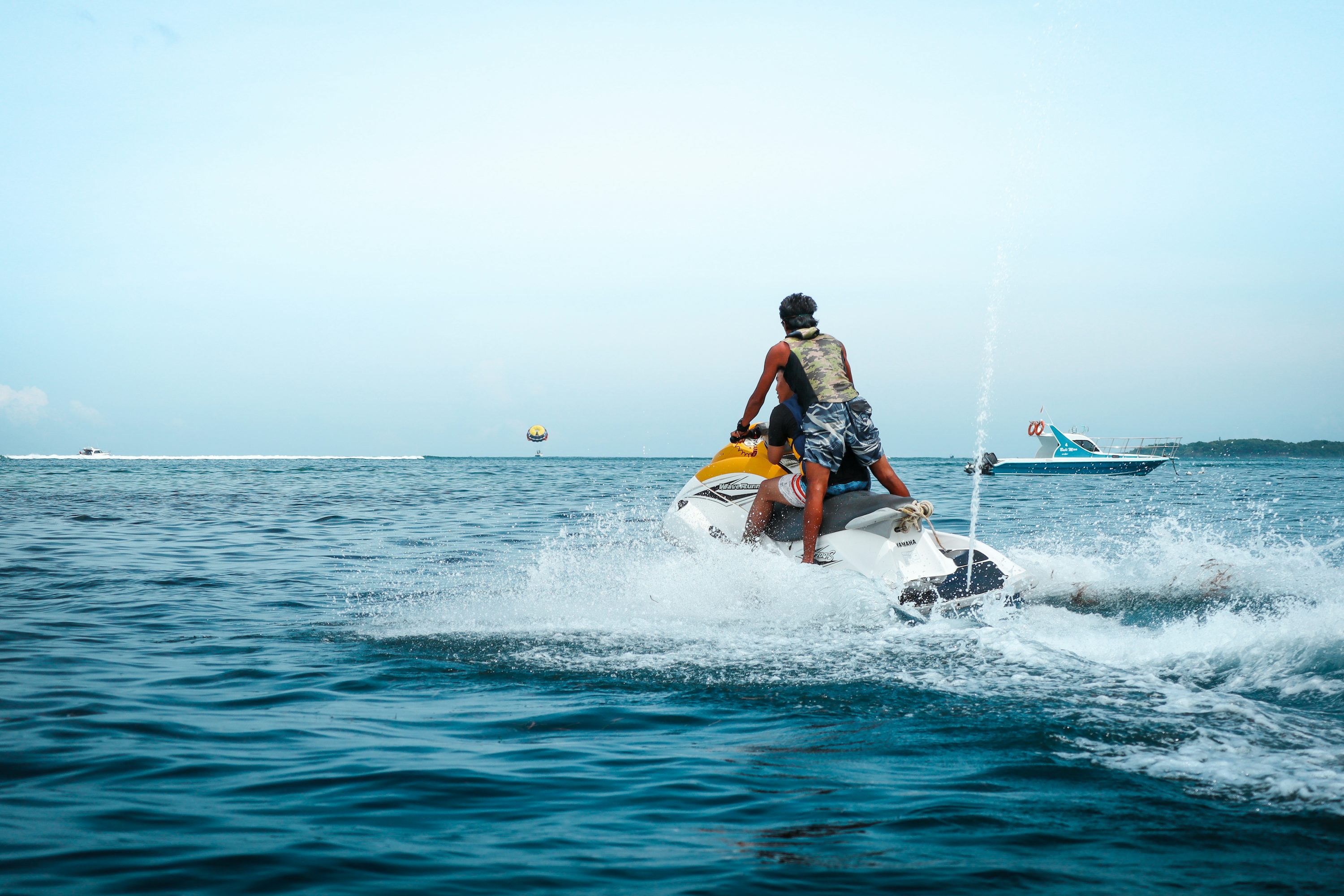 Jet ski rider operating on open ocean water.